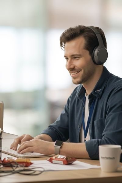 Friendly KachoTech support representative with headphones